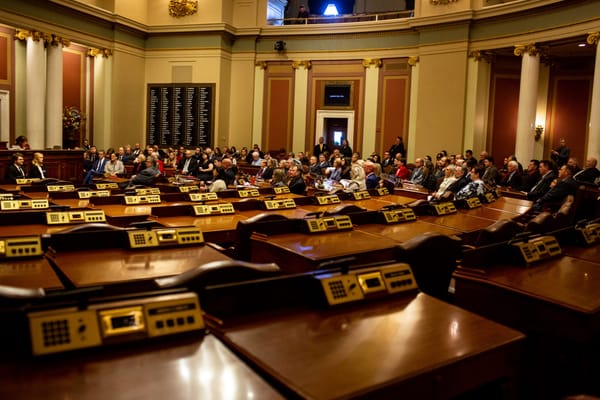 The Minnesota House chamber sits half empty